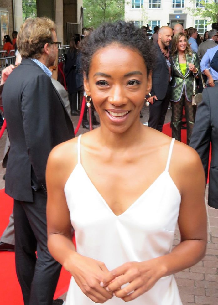 Betty Gabriel in white dress